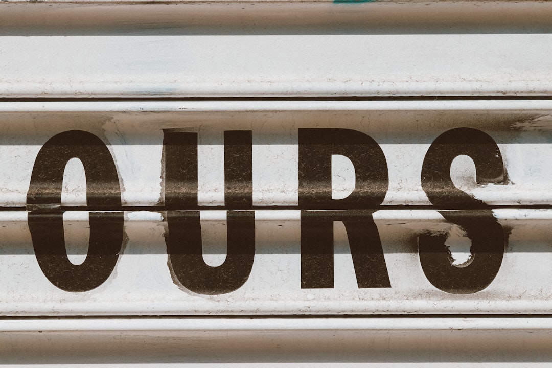 a close up of a sign that reads tours
